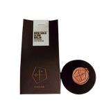 Rose gold glow balm with packaging on a white background